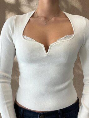 White ribbed knit long sleeve top with sweetheart cutout neckline going out